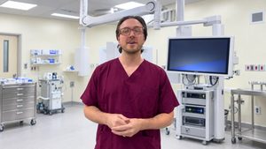 Clinical team member standing beside a robotic surgical system at the Robotics-Assisted Surgery and Oncology Centre, Imo Specialist Hospital, Umuguma.